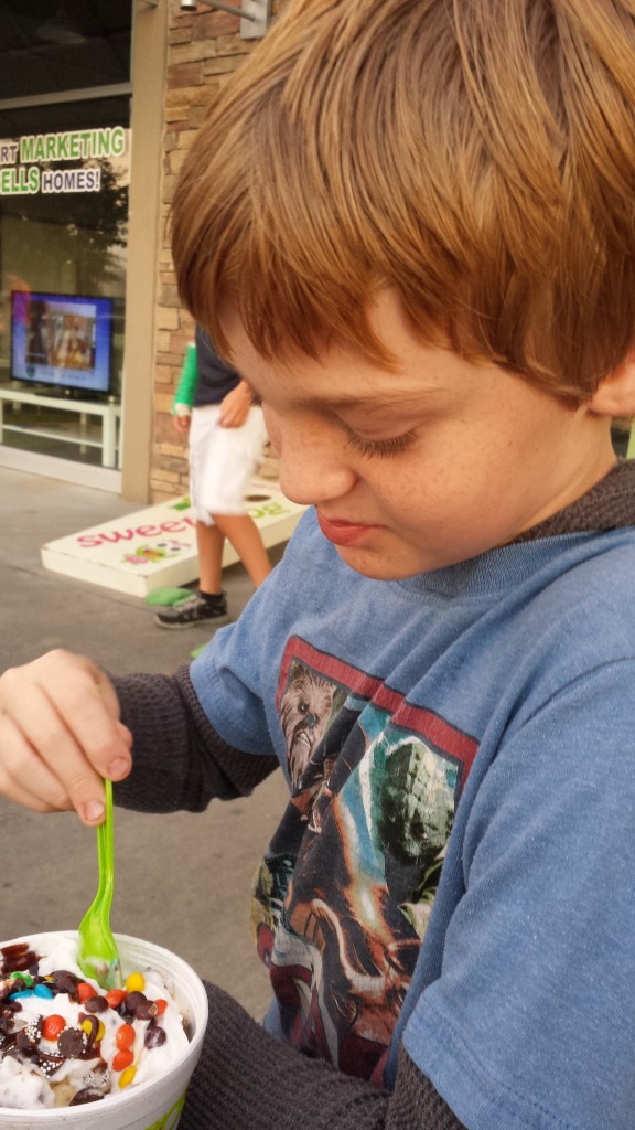 CootieBoy enjoying some froyo while watching people play cornhole.